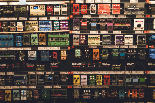 A wall of guitar pedals at a store